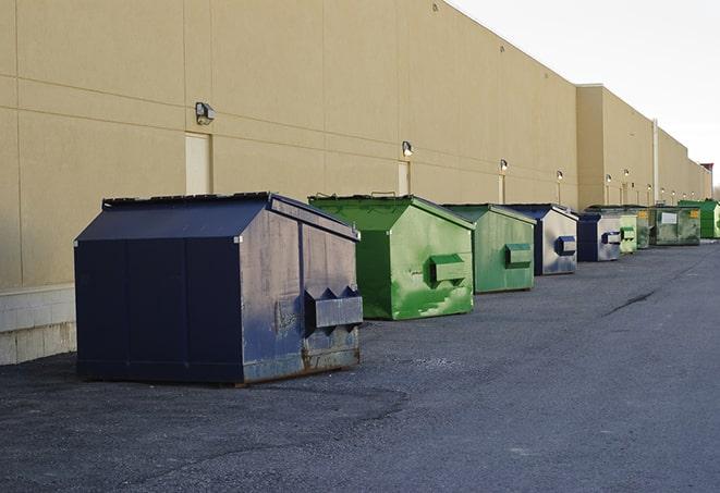 a series of colorful, utilitarian dumpsters deployed in a construction site in Poway